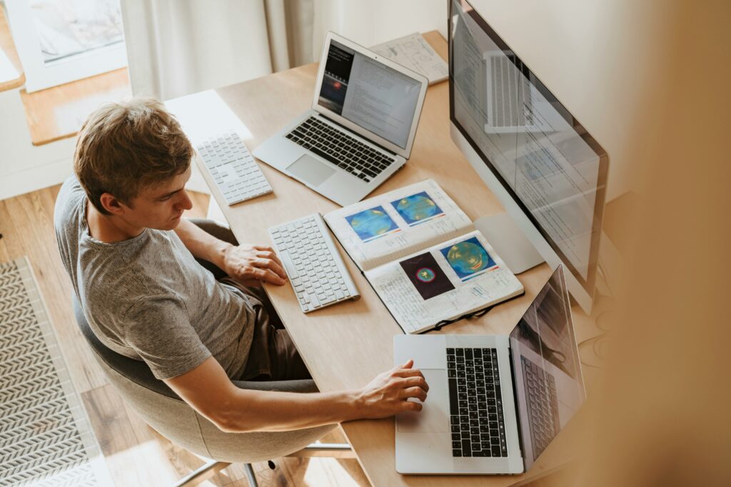 Remote worker utilizes multiple screens to make work more efficient. 