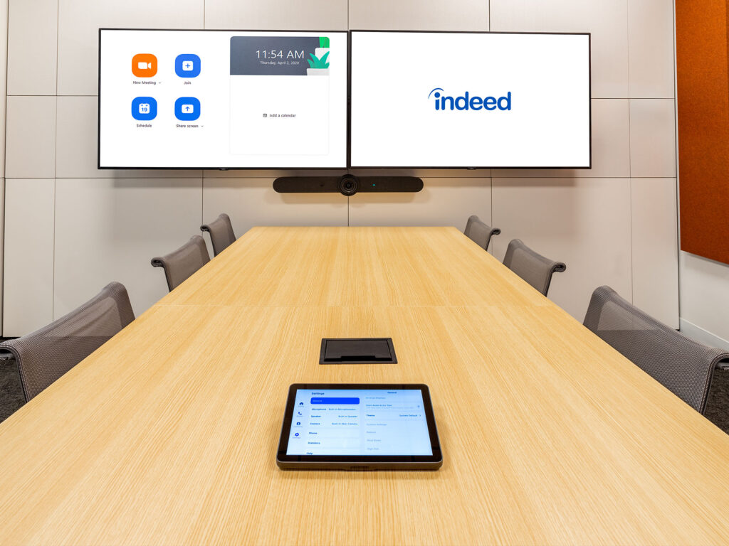 Hundreds of meeting spaces facilitate 4–40+ attendees, utilizing AI features for auto framing, tracking, camera switching, background noise filtering, voice recognition, as well as beam-forming ceiling mics that increase speech intelligibility.