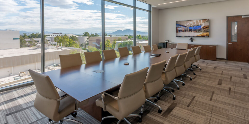 UNLV conference rooms include 85” UHD display, ceiling-mounted speakers, and media switcher, and 
Boardroom utilizes 85” UHD display, ceiling-mounted speakers, table array microphones, and touchscreen control panel.