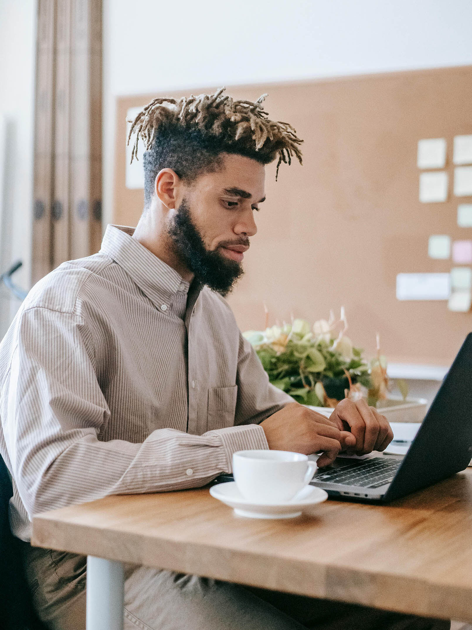 Work from home employee uses laptop to connect with coworkers.