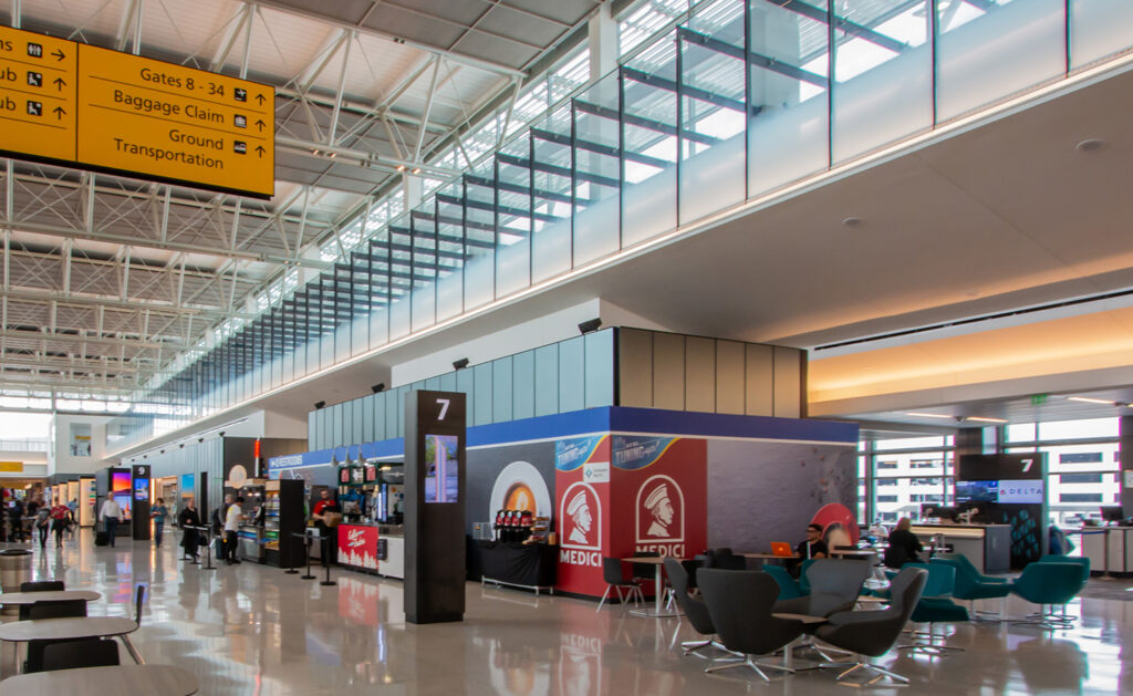 Austin-Berstron International Airport uses ambient noise sensors to analyze surrounding noise and adjust output volume to optimal level.