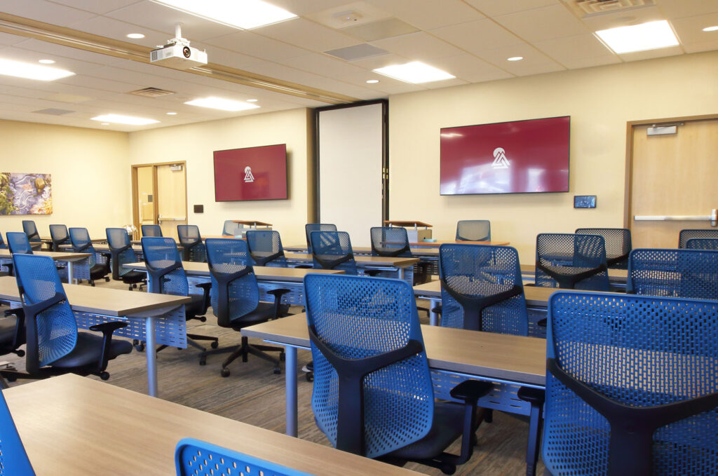 Presbyterian Health Simulation Center features 75” 4K flat panel displays, motorized projection screens and ceiling-mounted PTZ cameras for event capture